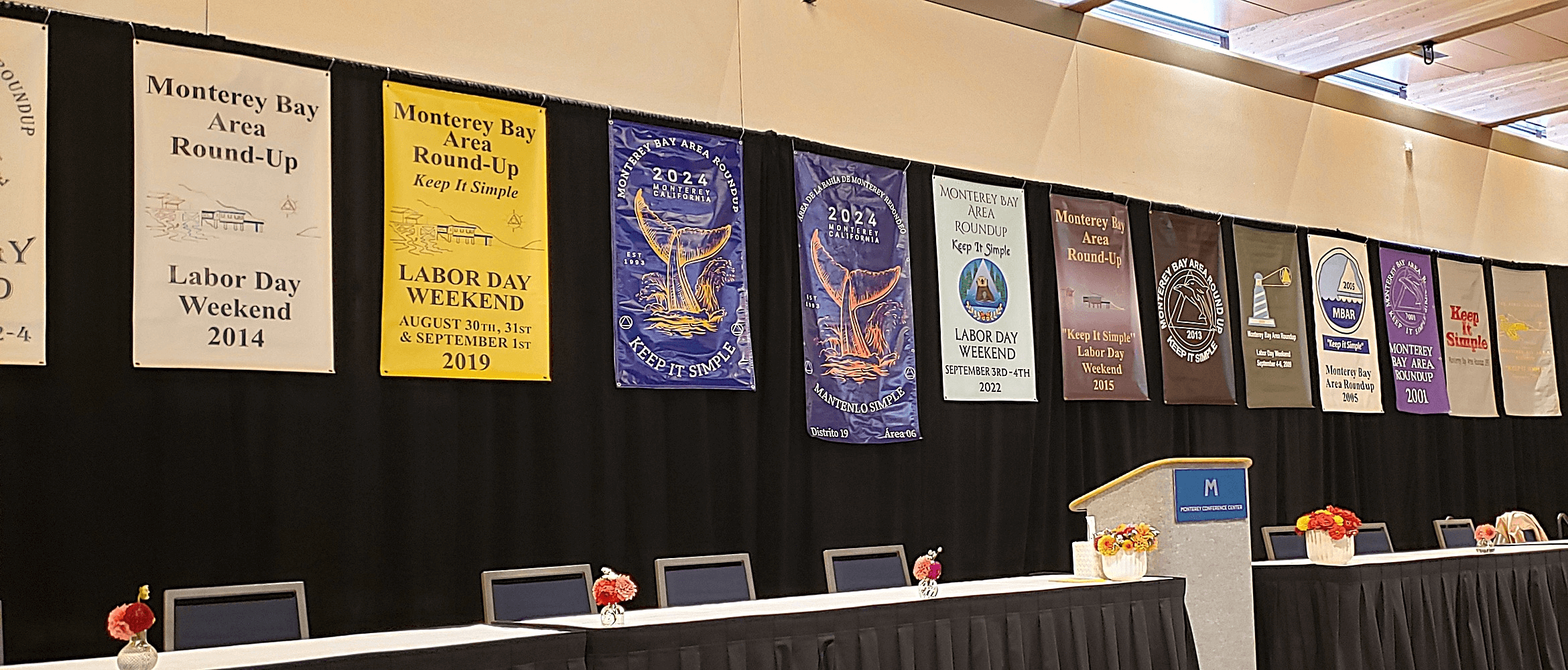 Main meeting room stage with A.A. conference banners.